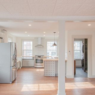 A kitchen with a refrigerator , stove , and sink.