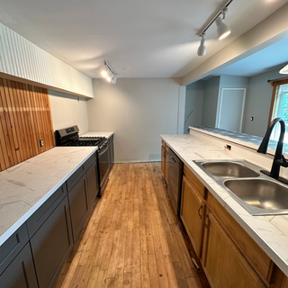 A kitchen with two sinks and a stove