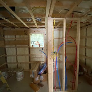A room with a lot of pipes hanging from the ceiling.