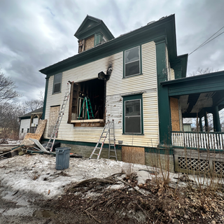 A house with a ladder on the side of it