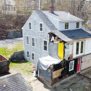 An aerial view of a house that is being demolished.