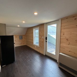 There is a refrigerator in the middle of the room.