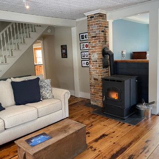 A living room with a couch , coffee table , and fireplace.