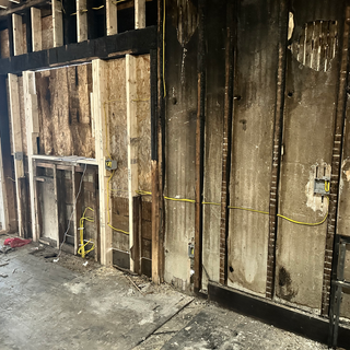 A room with a wooden frame and a yellow tape measure