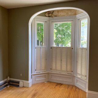 There is a large bay window in the middle of the room.