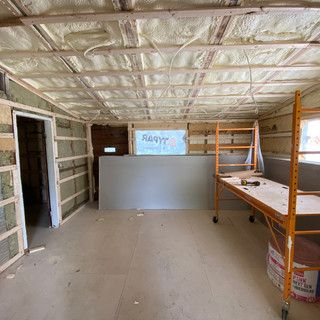 A room with a scaffolding and a table in it.