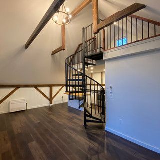 There is a spiral staircase in the middle of the room.