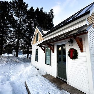 A white house with a wreath on the front door