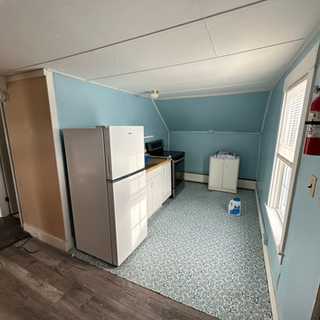 A kitchen with blue walls and a white refrigerator