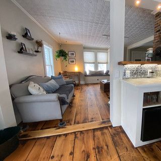 A living room with hardwood floors and a couch.