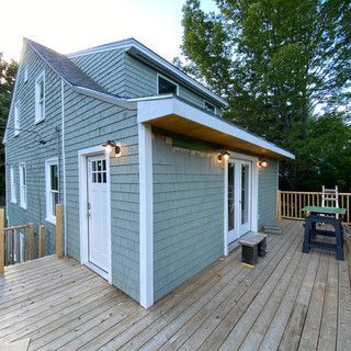 A house with a deck and a picnic table on it