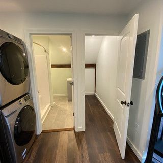 A laundry room with a washer and dryer stacked on top of each other.