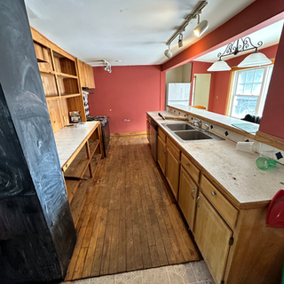 A kitchen with wooden cabinets and two sinks