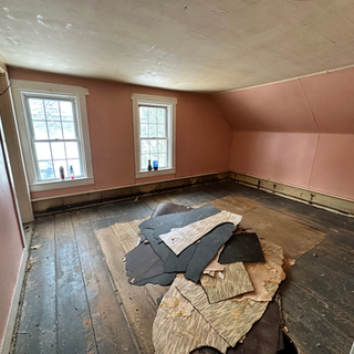 A room with pink walls and a wooden floor