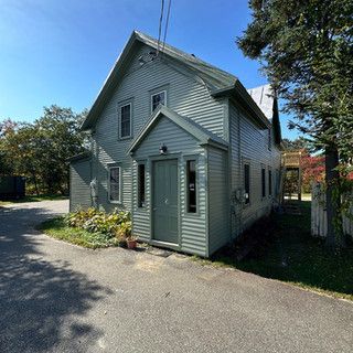 A house with a green door and a green roof