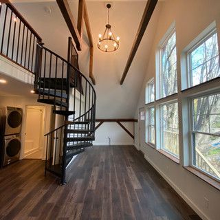 There is a spiral staircase in the middle of the room.