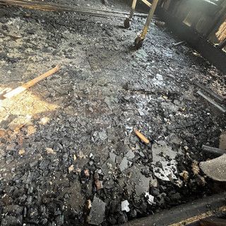 A room with a lot of broken glass on the floor.
