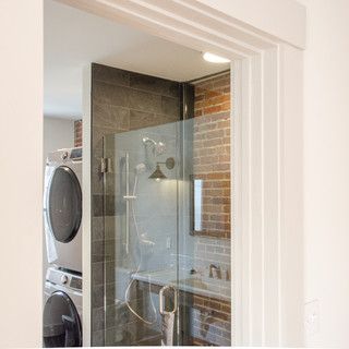 A washer and dryer are stacked on top of each other in a bathroom.