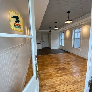 An empty room with a sticker on the wall that says ' u.s. mail '