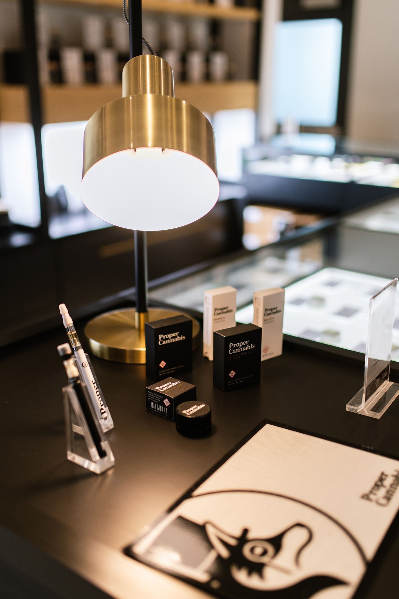 A table with a lamp and a vape pen on it.