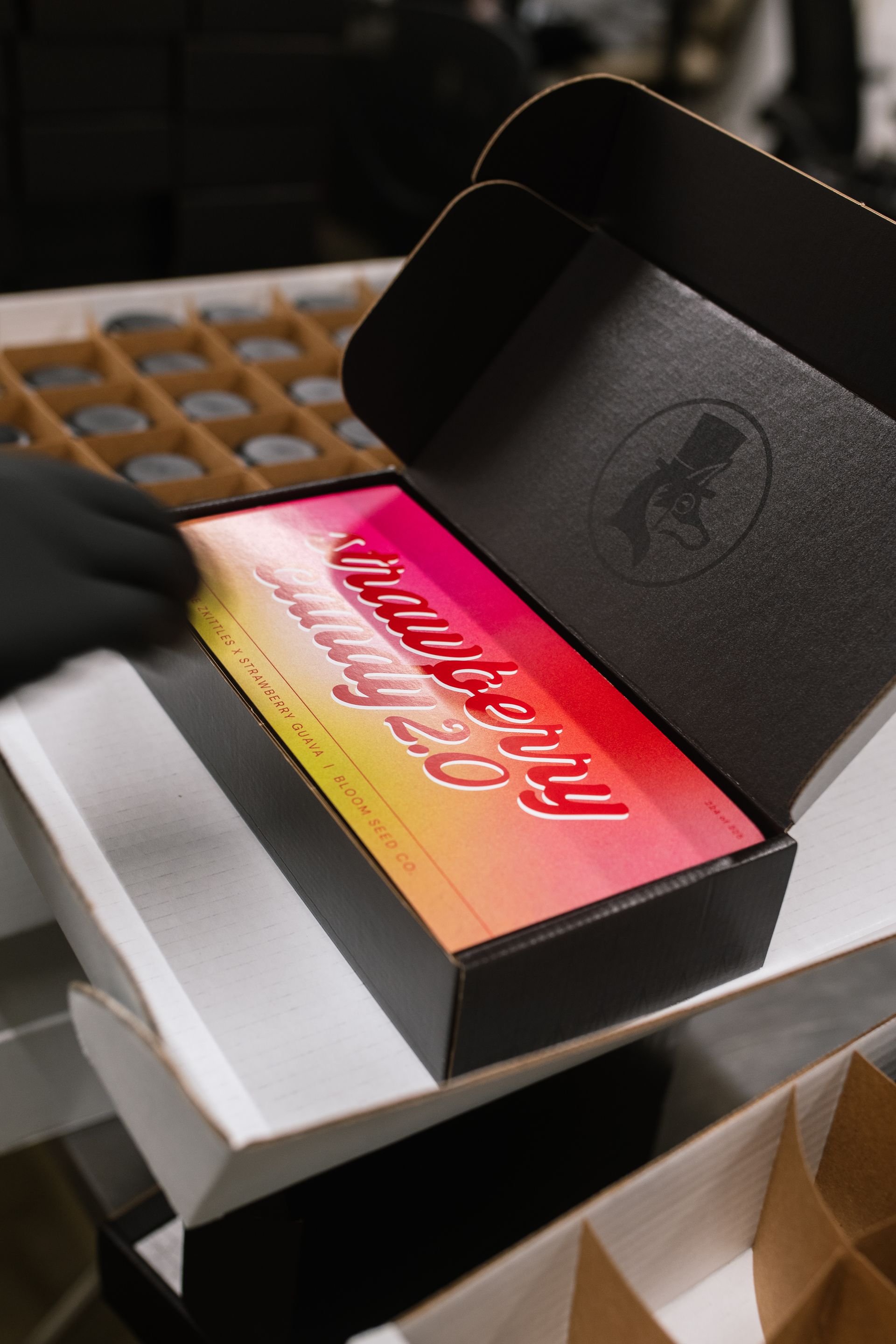 black box with strawberry candy graphic on top