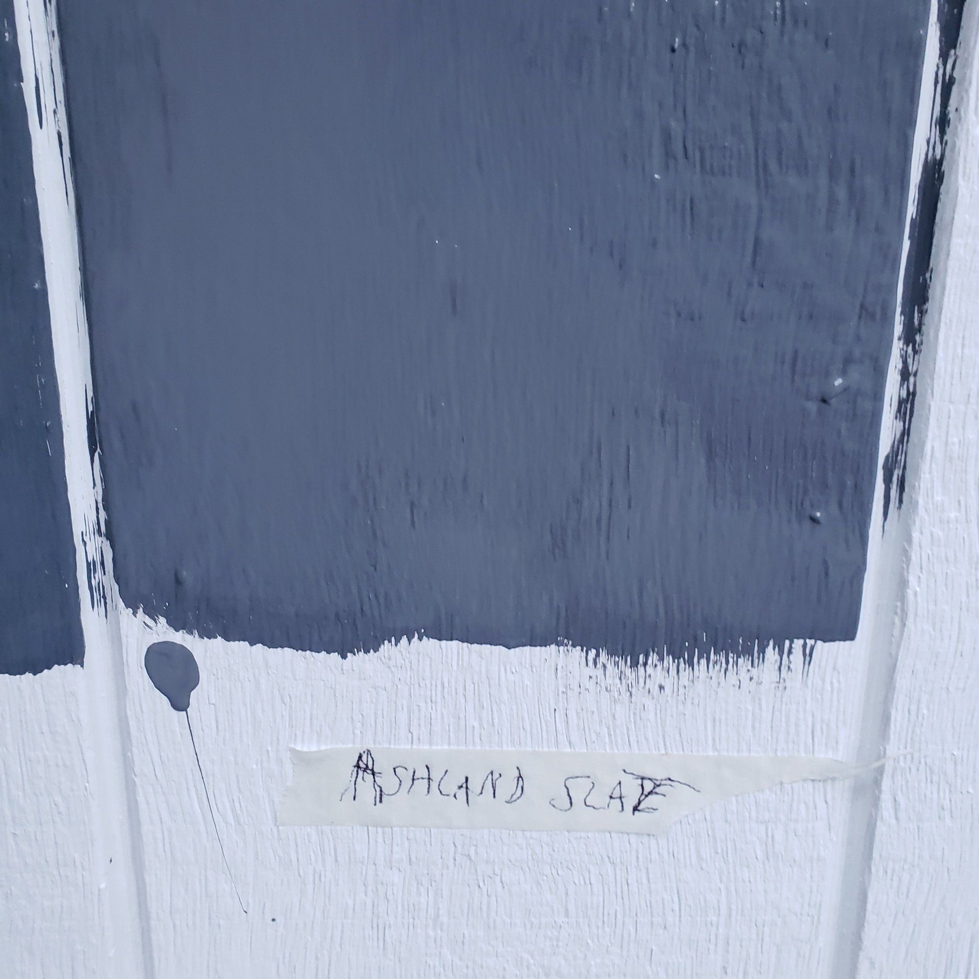 A swatch of blue paint next to a swatch of white paint.