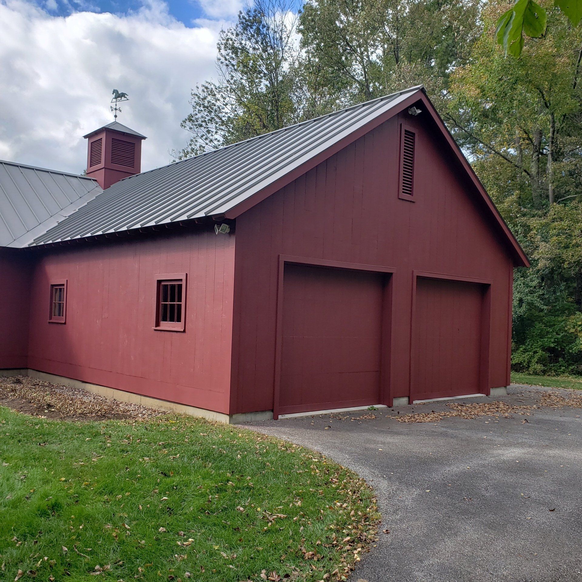 A house painted red with a chimney on top of it