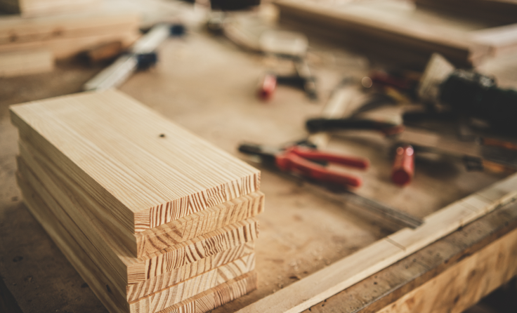 A stack of wood sitting on top of a wooden table.