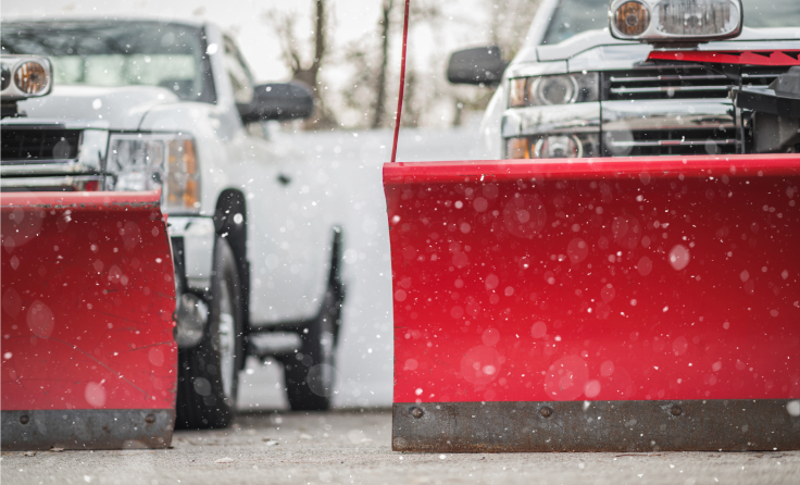 Two trucks with snow plows.