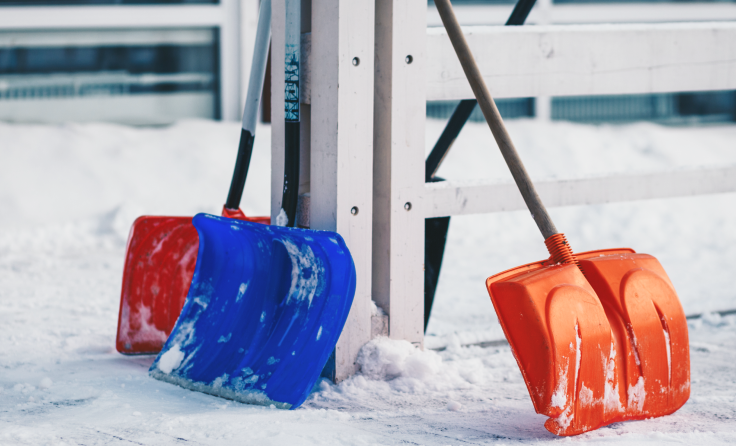 Snow shovels in a snowy area.