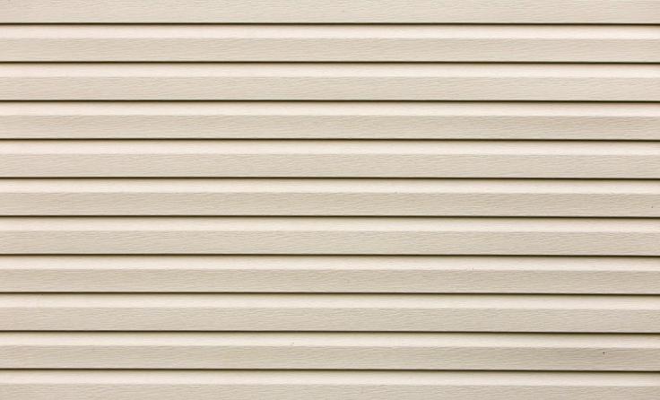 A close up of a white vinyl siding on a house.