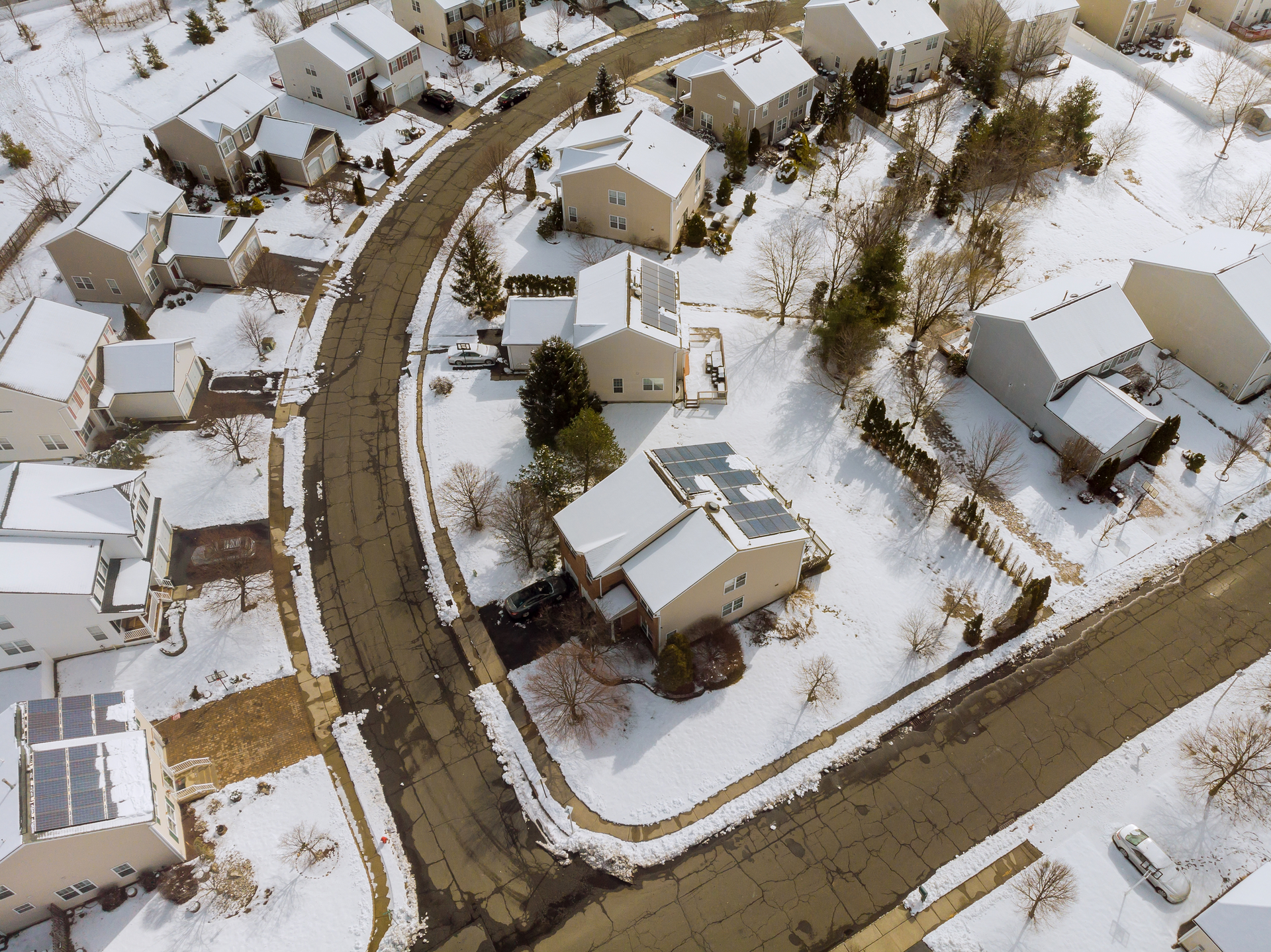 An aerial view of houses with snow everywhere.