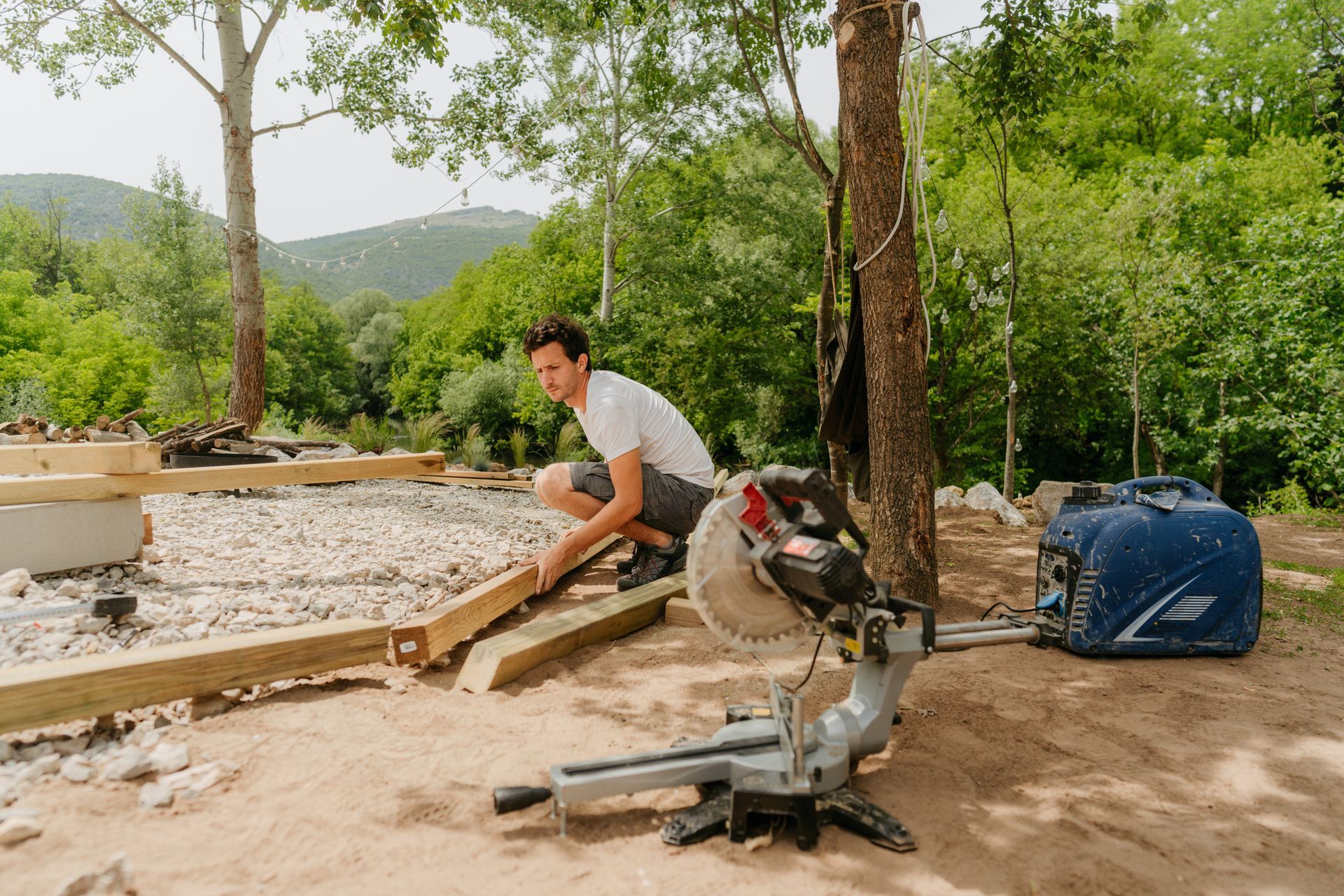 Outdoor living contractors installing a custom wooden patio in a modern backyard setting. Outdoor living contractors installing a custom wooden patio in a modern backyard setting.