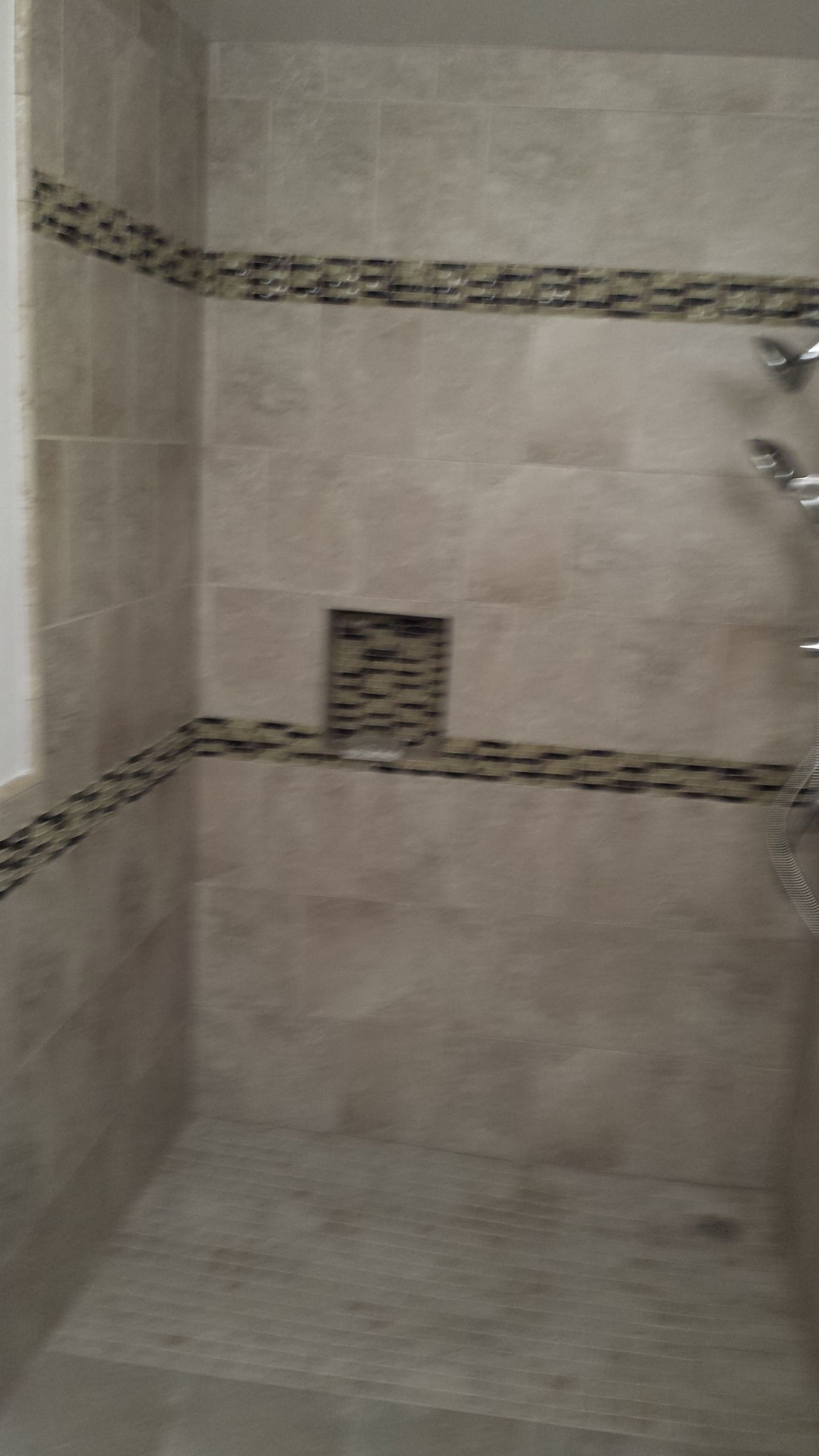 A bathroom with a walk in shower and a sink.