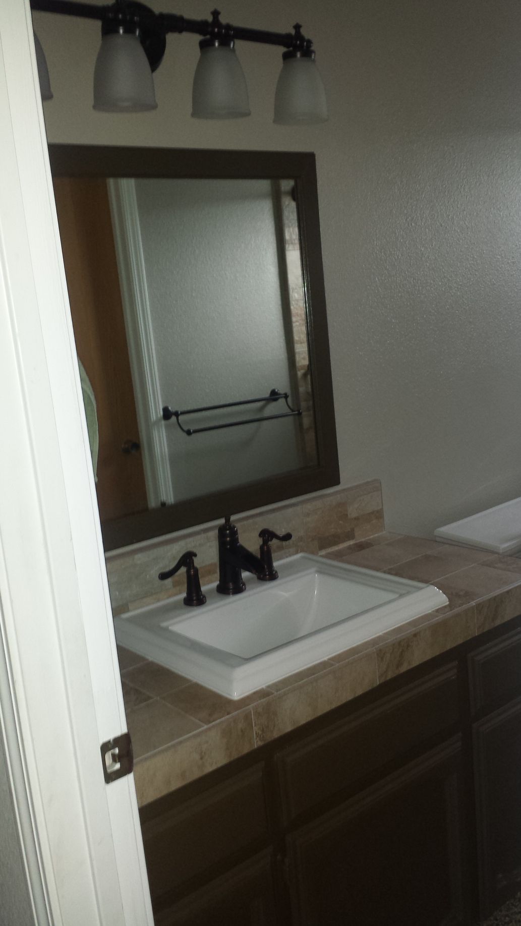 A bathroom with a sink and a mirror.