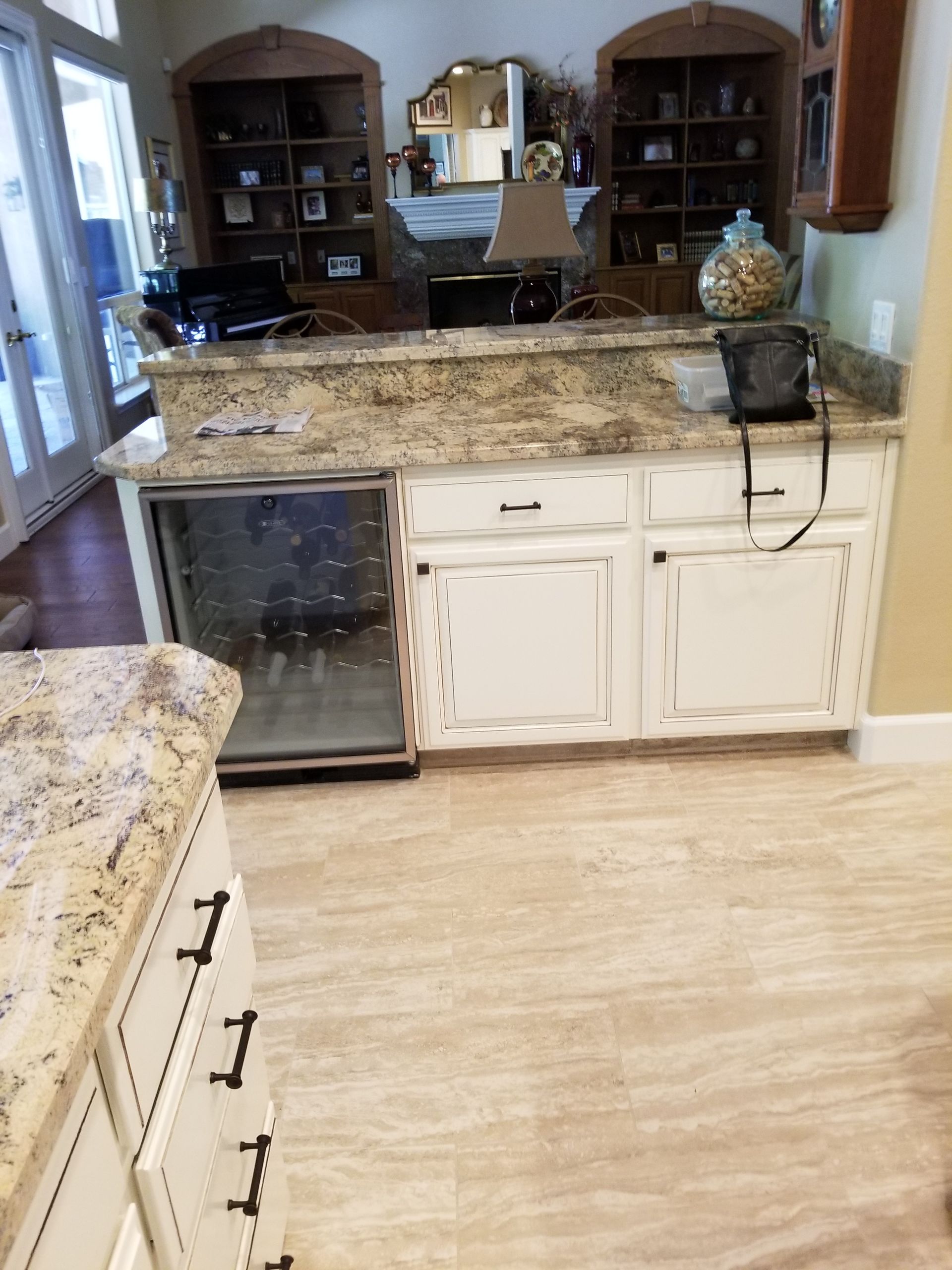 A kitchen with granite counter tops and white cabinets