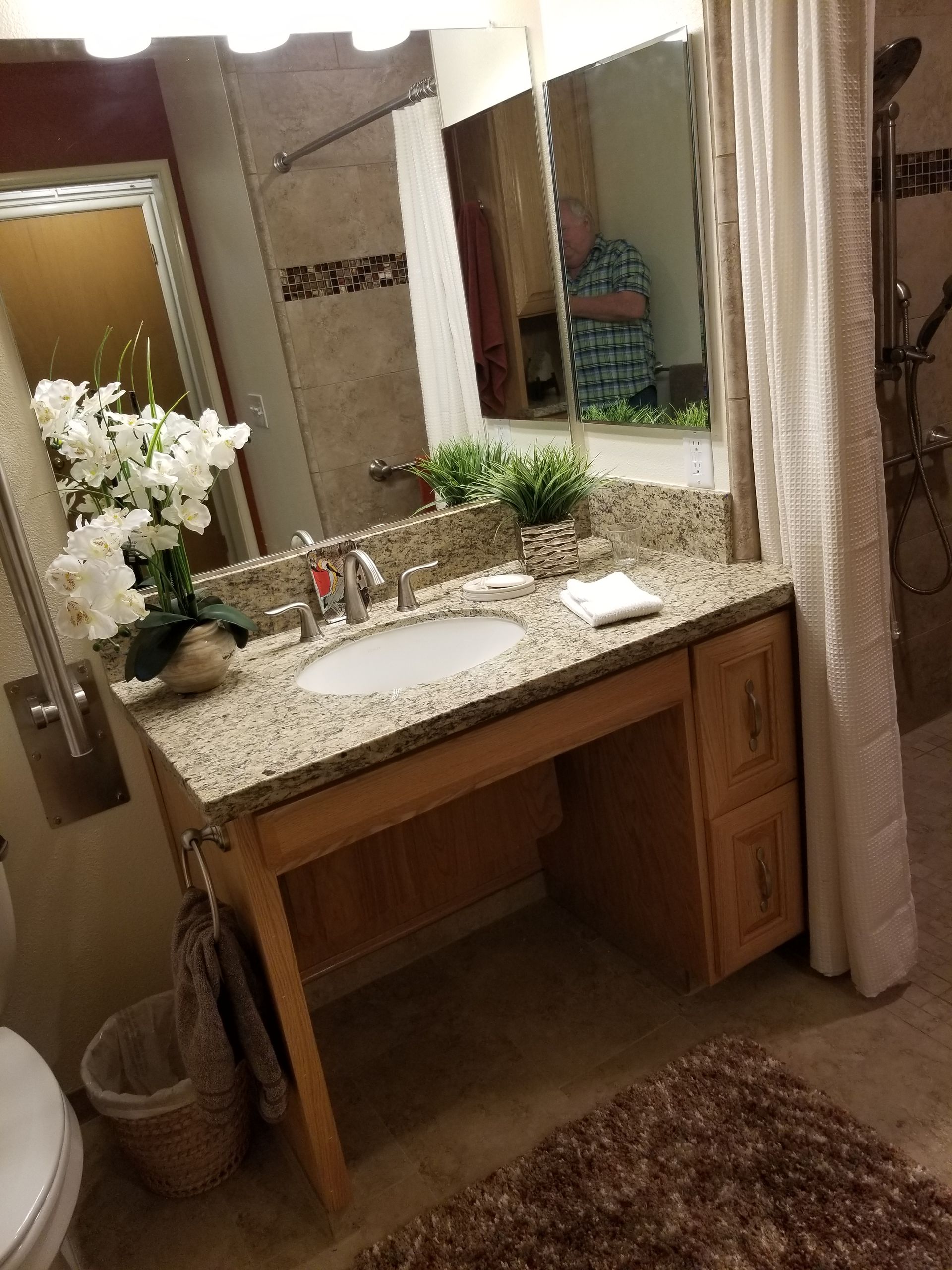 A bathroom with a sink , toilet , and mirror.