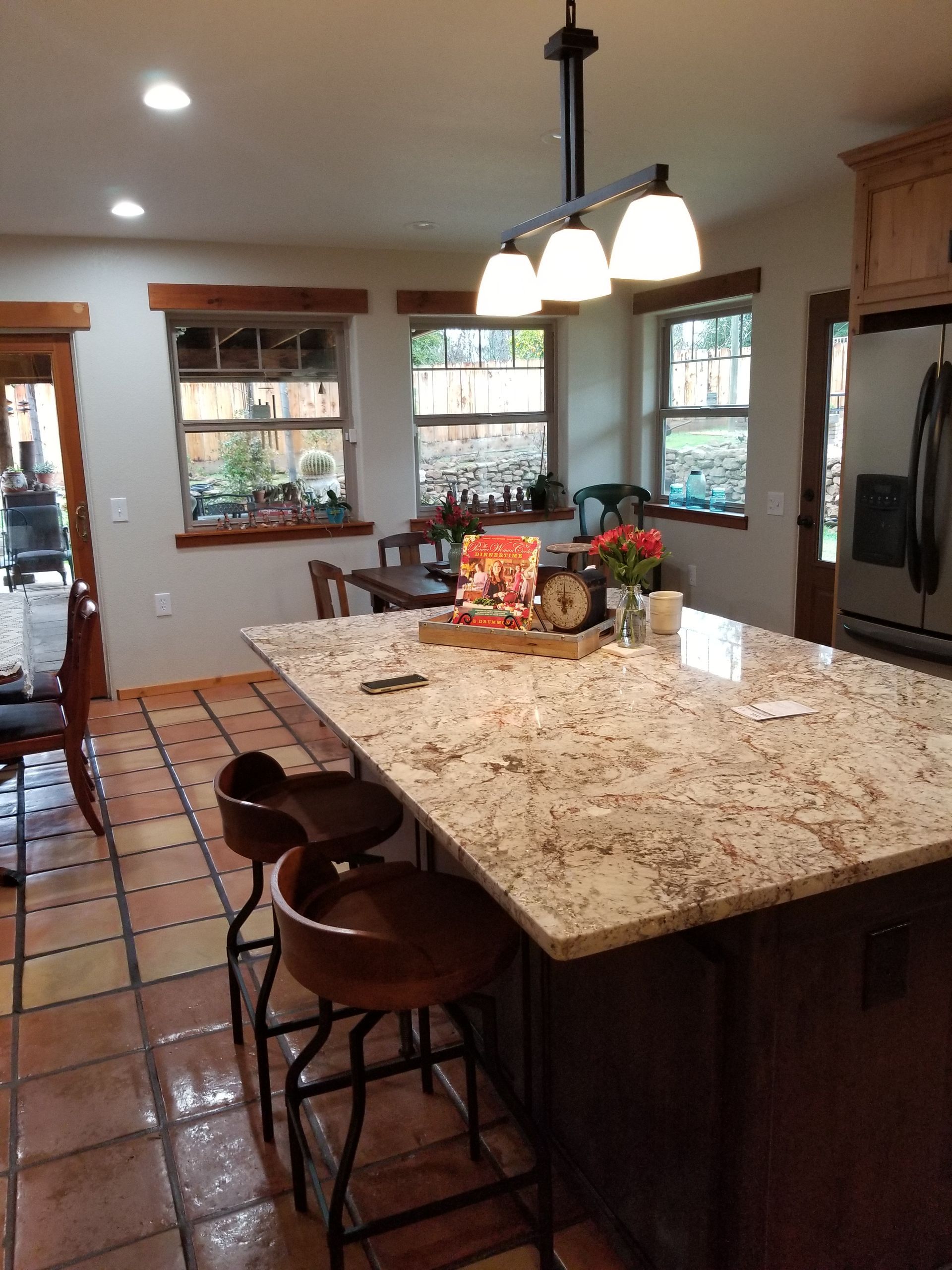 A kitchen with a large island and stools