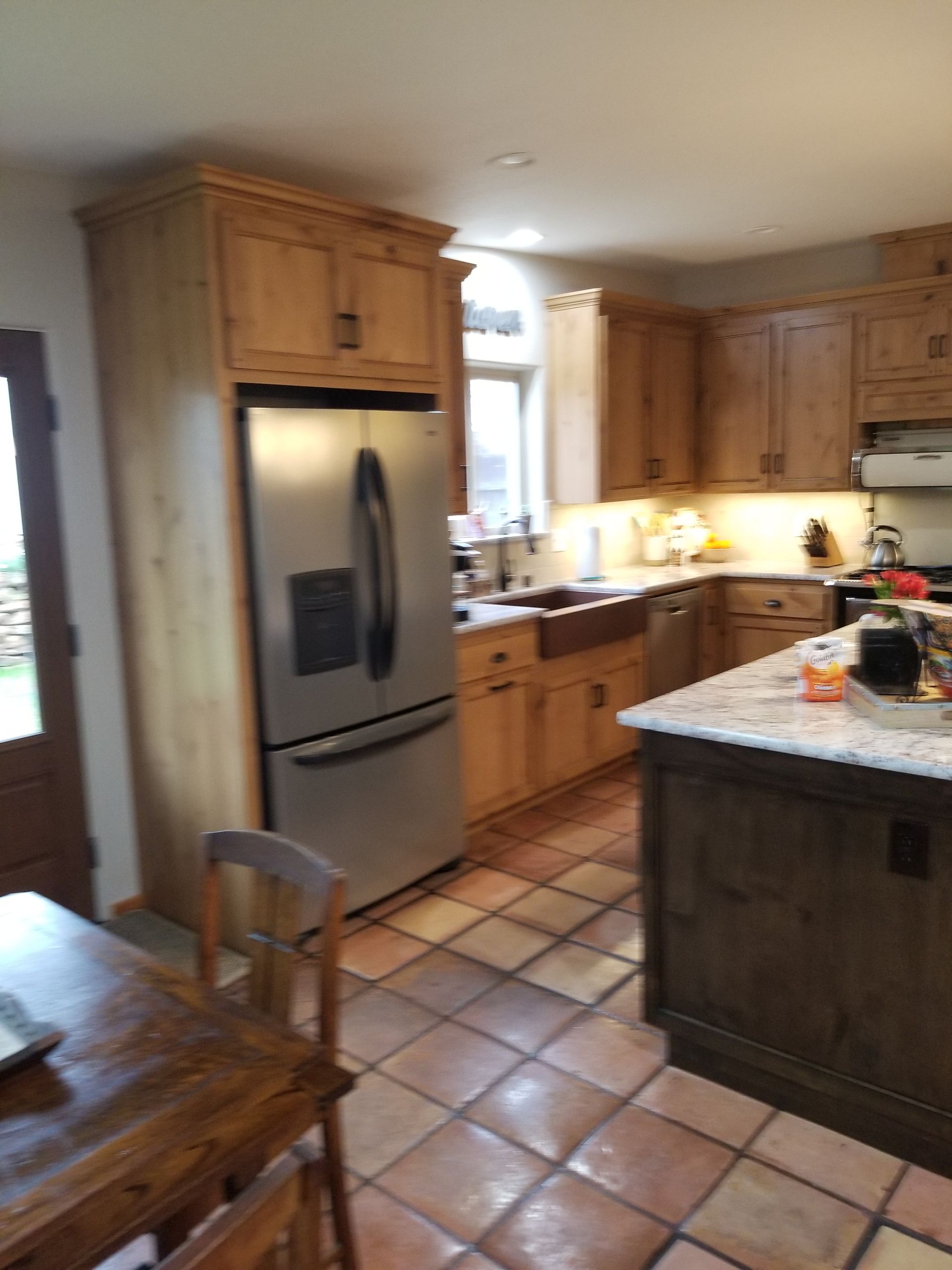 A kitchen with stainless steel appliances and wooden cabinets
