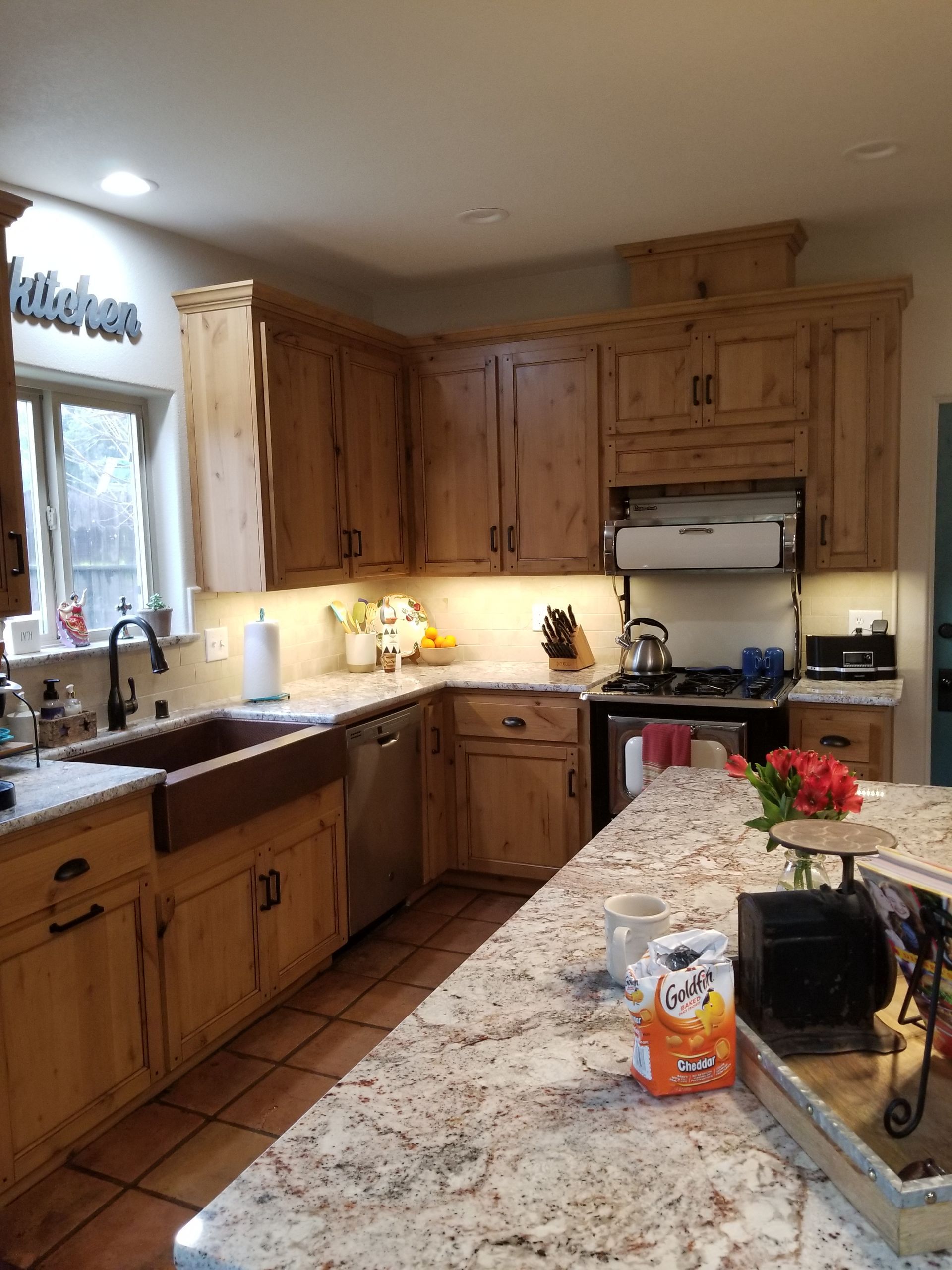 A kitchen with wooden cabinets and granite counter tops