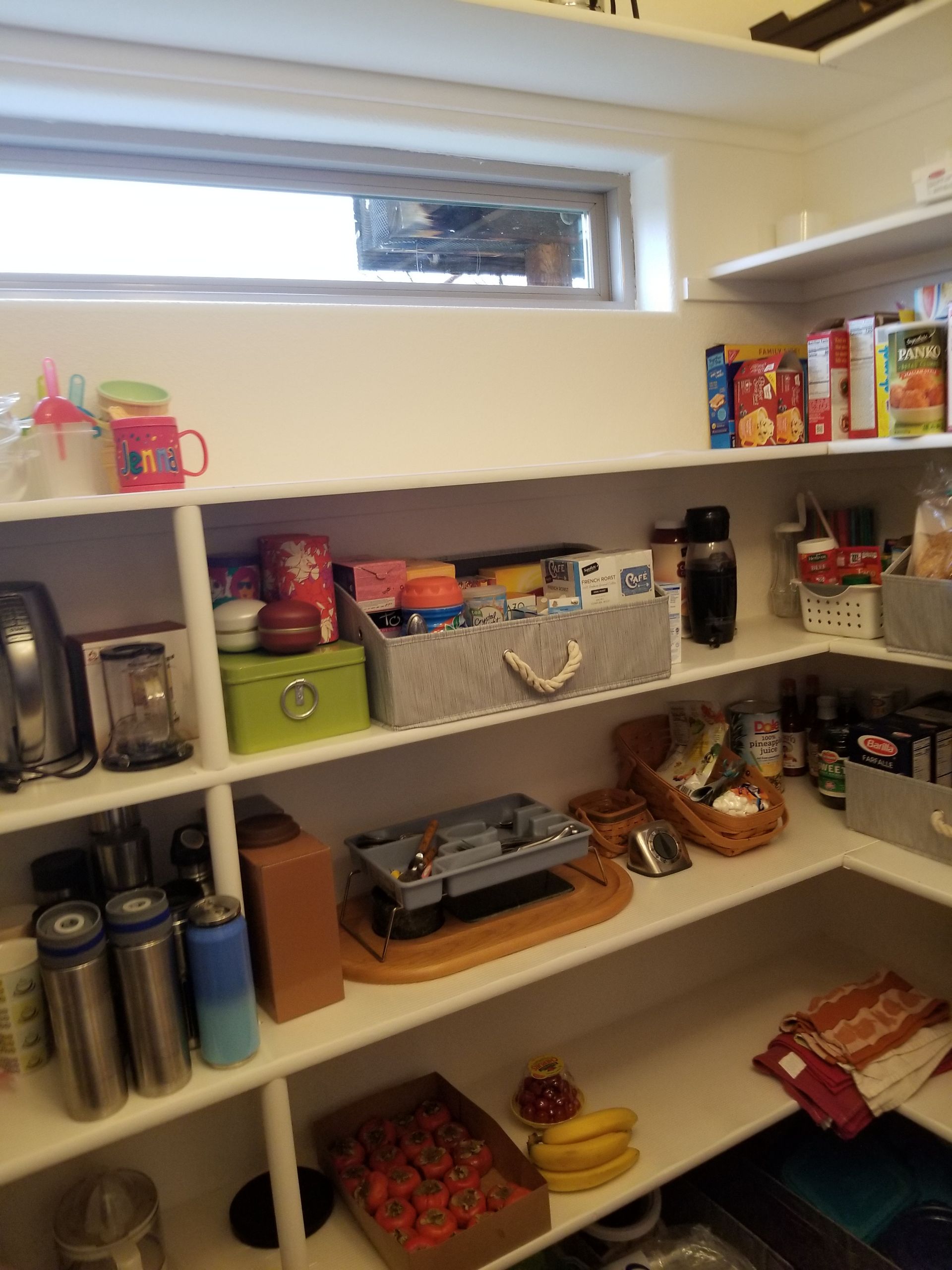 A pantry filled with lots of food and a window