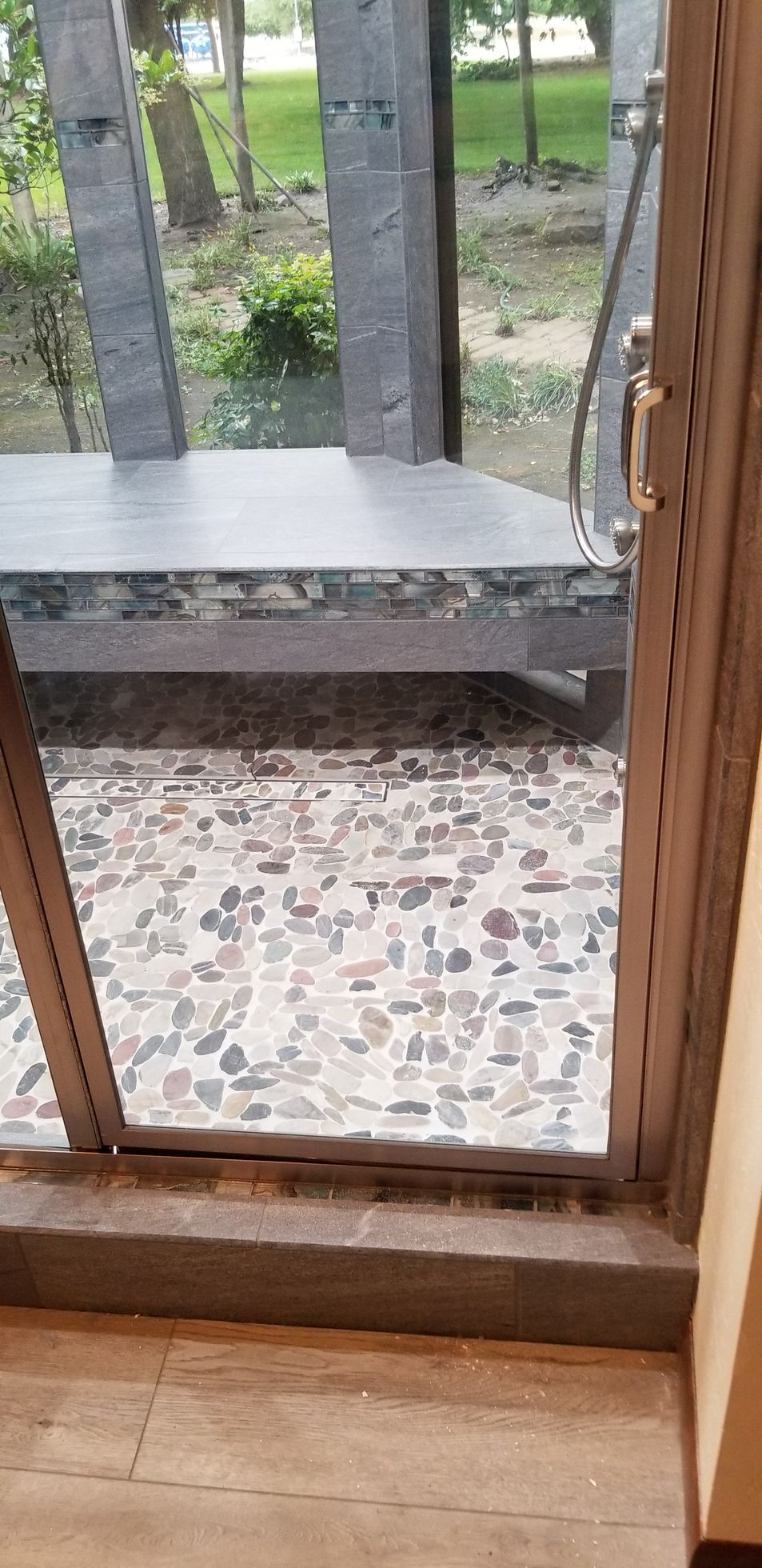 A sliding glass door with a view of a park through it.