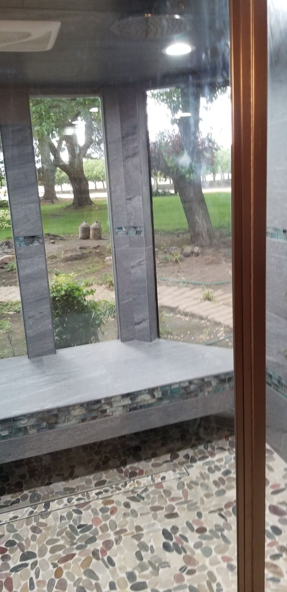 A view of a park through a window in a building.