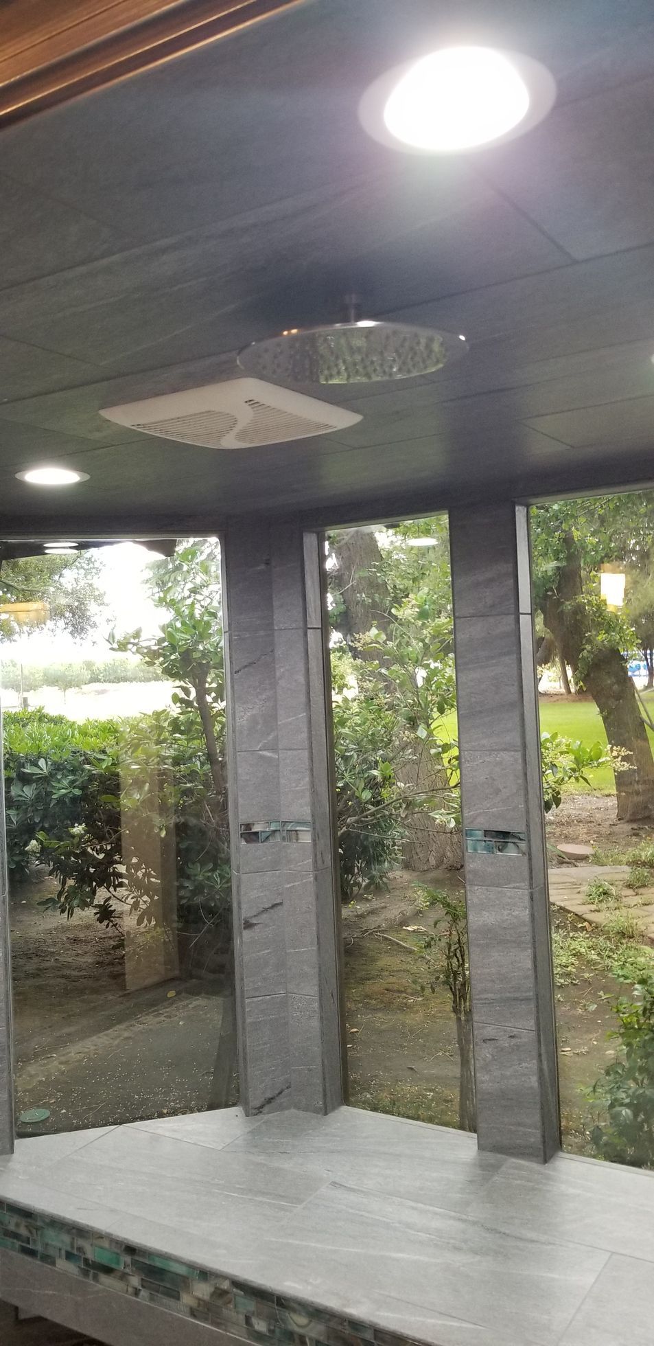 A room with a lot of windows and a ceiling light.