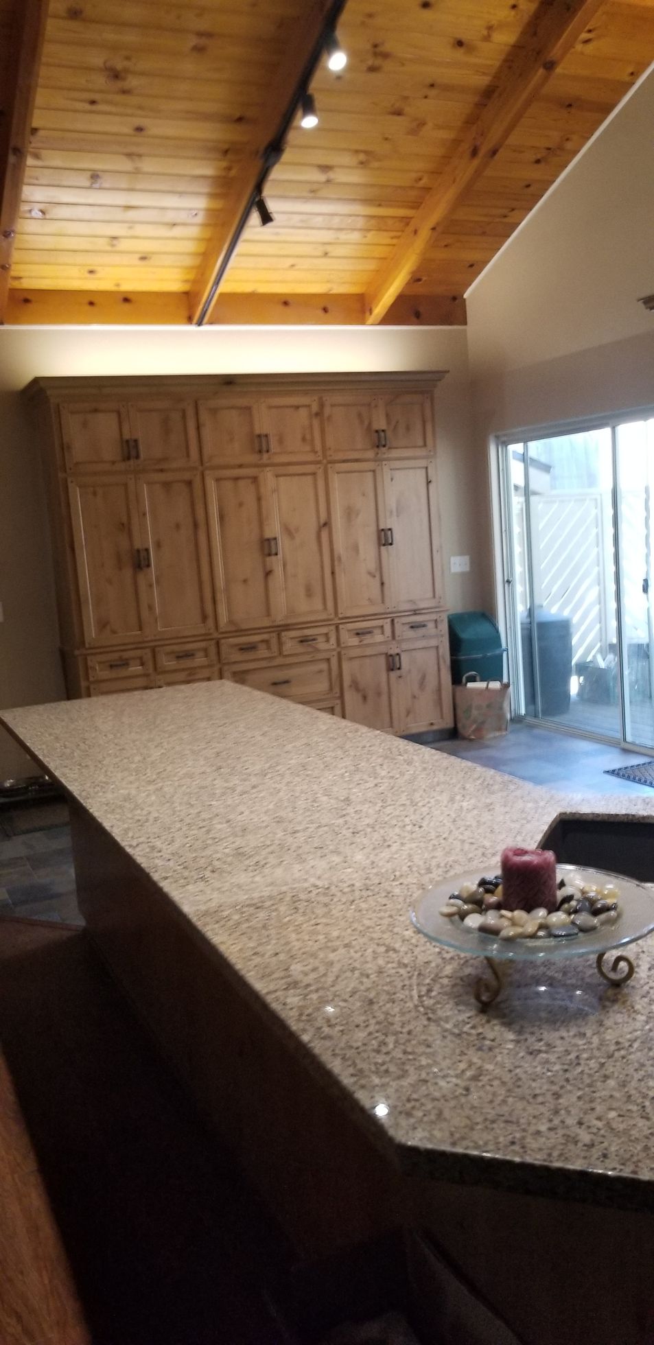 There is a candle on the counter in the kitchen.