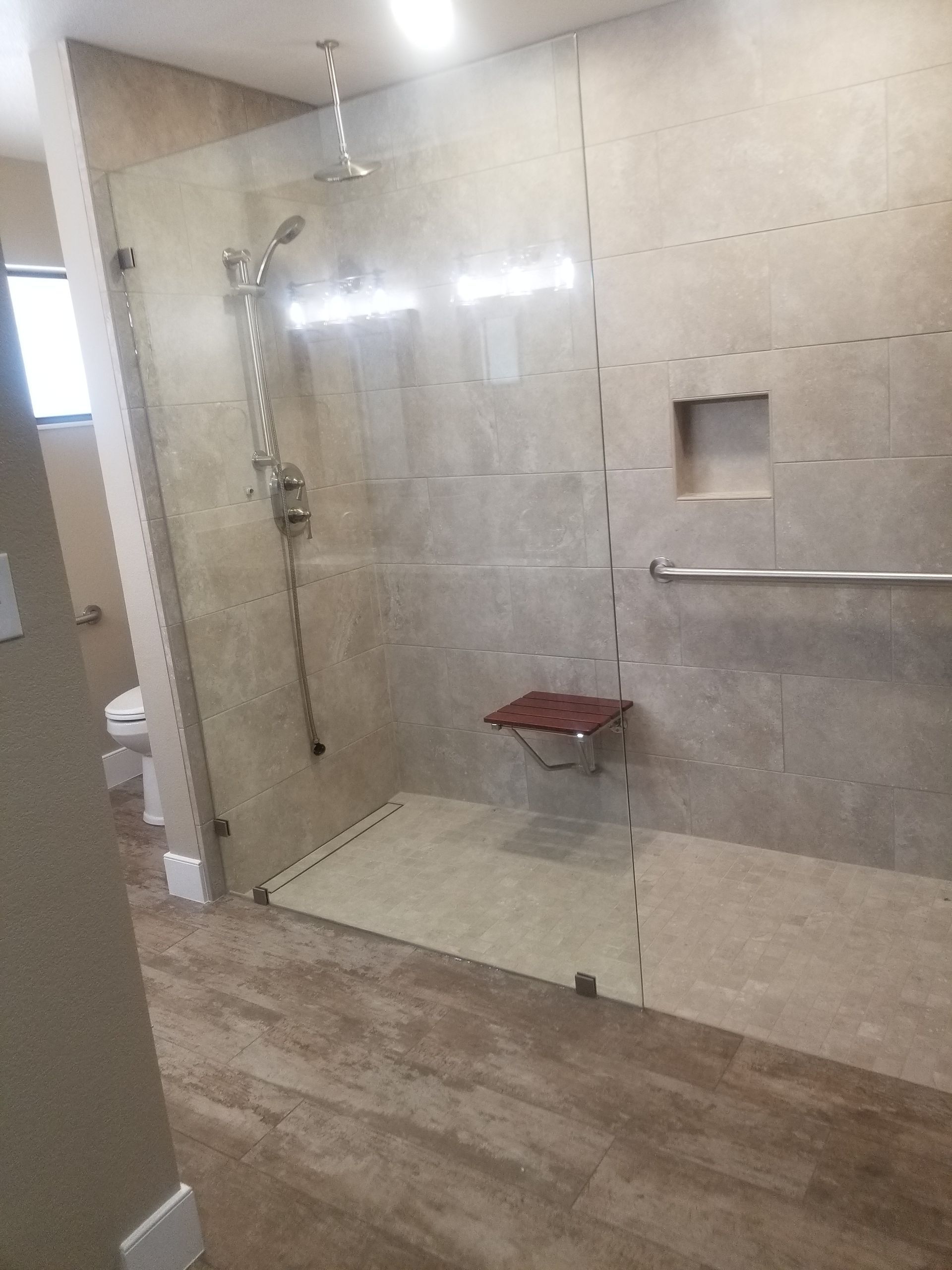 A bathroom with a walk in shower and a toilet.