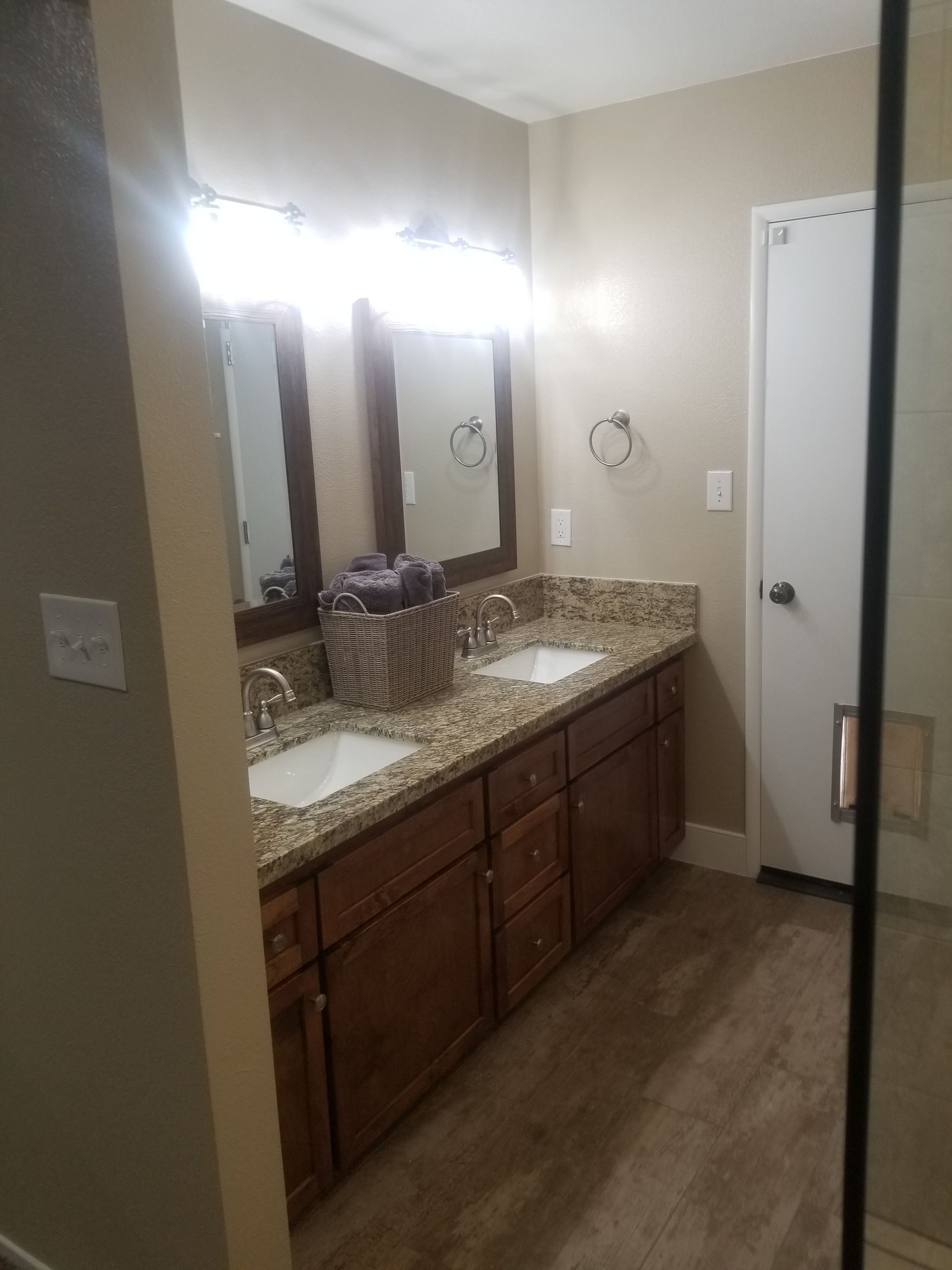 A bathroom with two sinks and two mirrors.