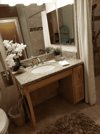 A bathroom with a sink , mirror and toilet.