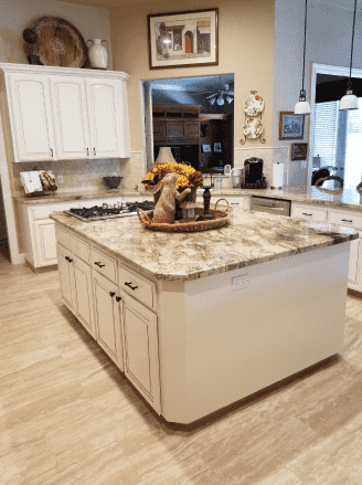 A kitchen with a large island in the middle of it.
