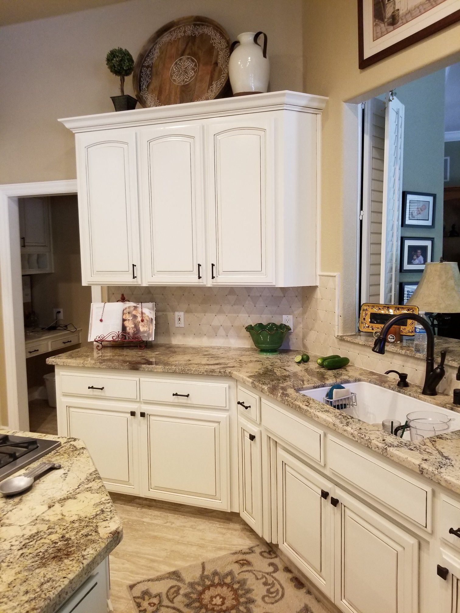 A kitchen with white cabinets and granite counter tops